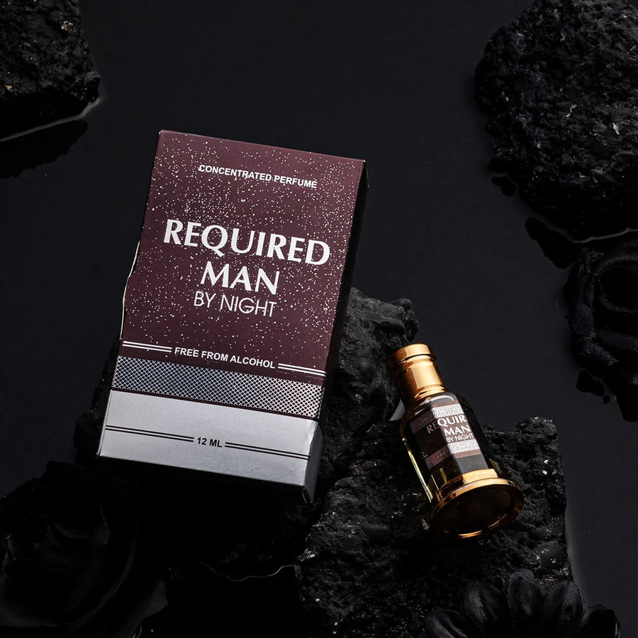 Required Man By Night concentrated perfume bottle and box on black volcanic rocks