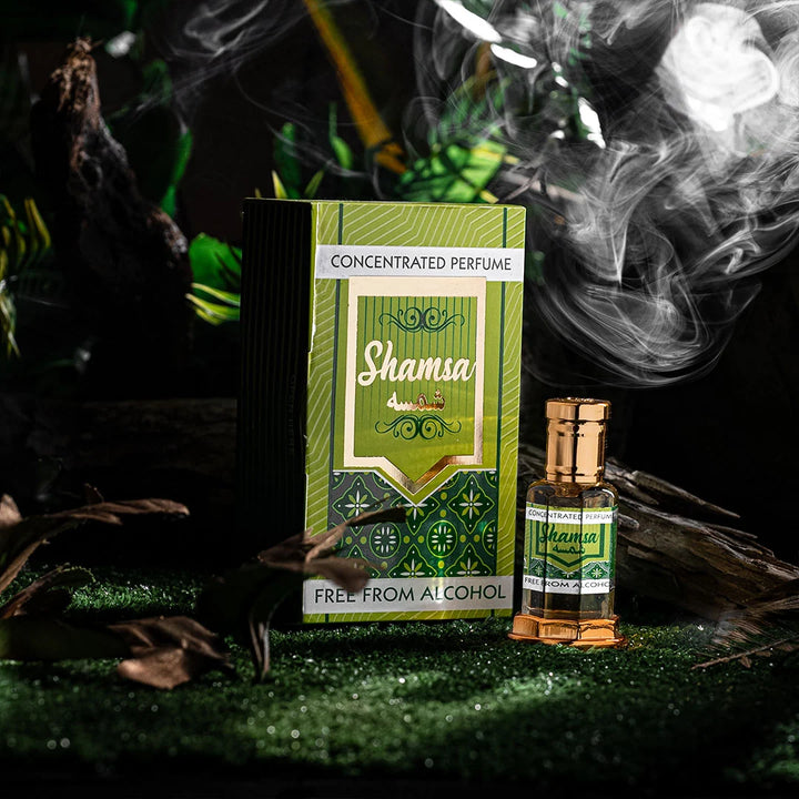 Shamsa concentrated perfume bottle and box with smoke in a dark natural setting