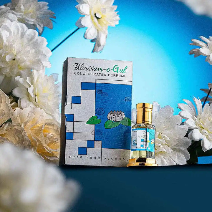 Tabassum-e-Gul concentrated perfume bottle and box surrounded by white flowers